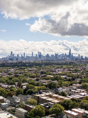 Wide-angle view of a city skyline with residential and commercial buildings.