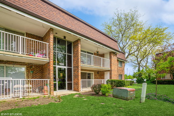 Front view of a two-story brick building with balconies.