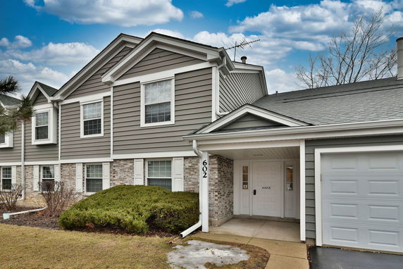 Front view of a two-story house with a garage.