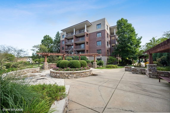 Front view of a multi-story apartment building with balconies.