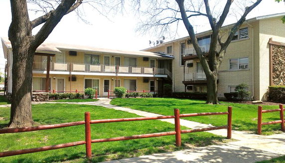 Front view of a two-story apartment building with balconies.