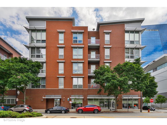 Front view of a multi-story brick apartment building.