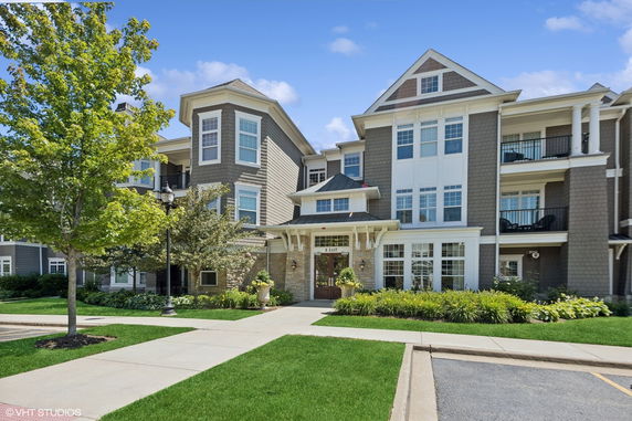 Front view of a multi-story residential building with multiple balconies.