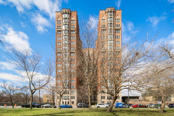 Front view of a tall brick building with Gothic architectural elements.
