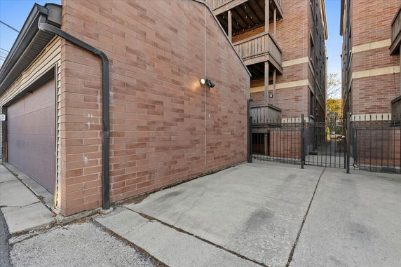 Front view of a brick apartment building with multiple balconies.