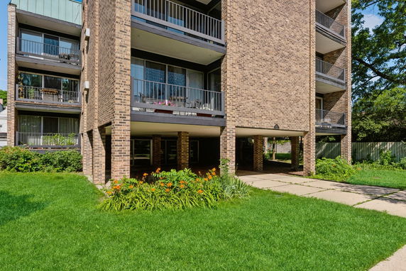 Front view of a brick apartment building with balconies.