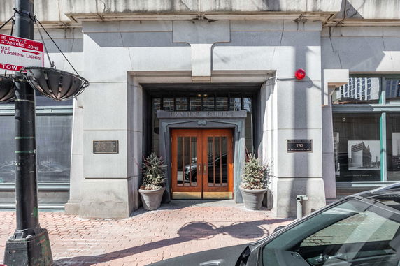 Front view of a building entrance with wooden double doors labeled Printers Building.