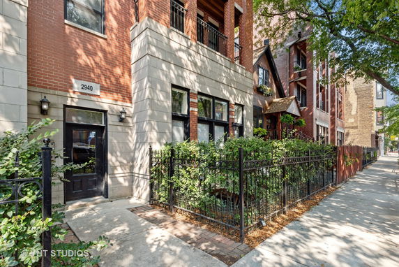 Front view of a multi-story brick building with street access.
