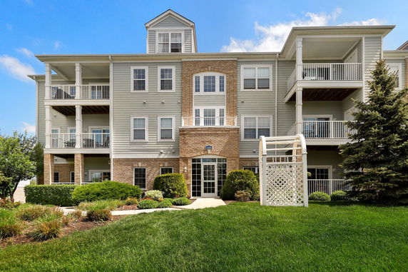 Front view of a multi-story residential building with balconies.