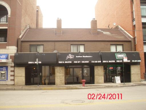 Front view of a two-story building with a restaurant on the ground floor.