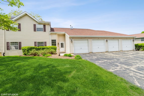 Front view of a two-story house with multiple garages.