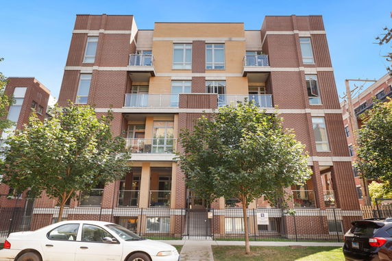 Front view of a multi-story residential building with balconies.