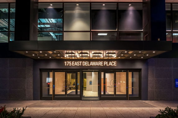 Front view of a building with large glass entrance and signage.