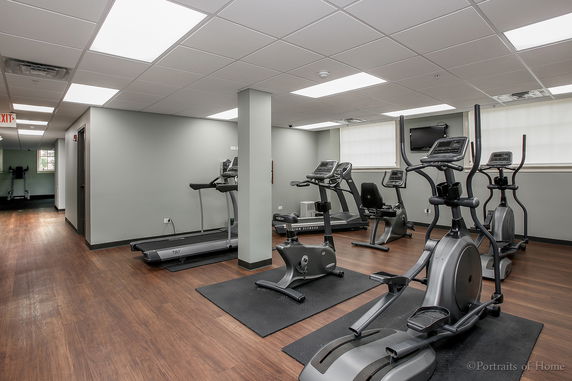 Indoor gym area with various exercise machines.