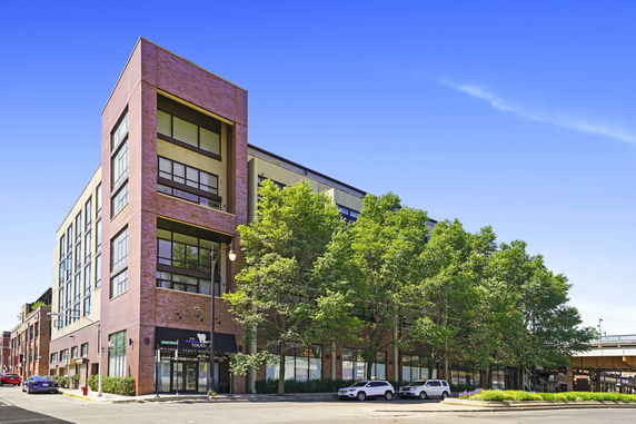 Front view of a multi-story commercial building with large windows.