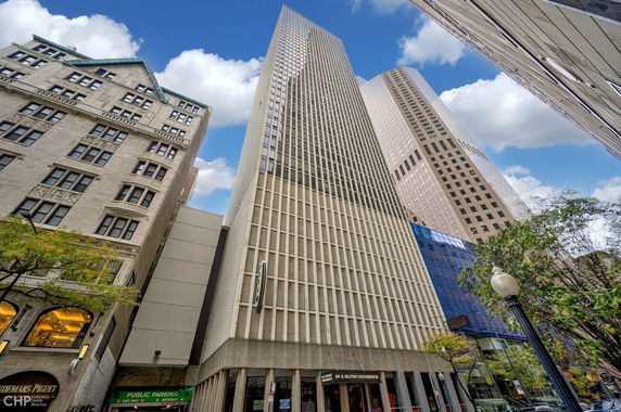 Front view of a tall, modern commercial building with a grid-like facade.