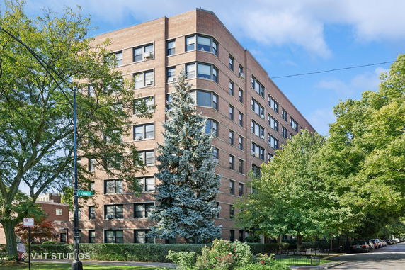 Front view of a multi-story brick apartment building.
