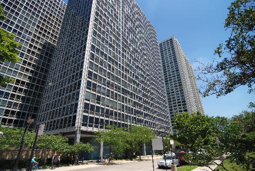 Front view of a high-rise building with a modern grid-like facade.