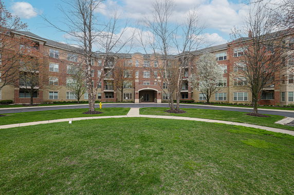Front view of a multi-story building with brick and stone exterior.