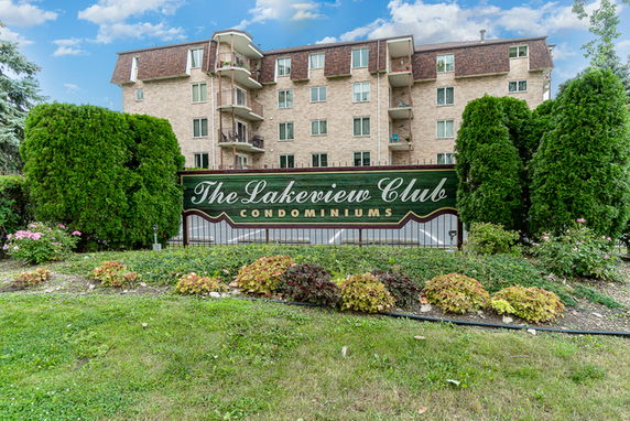 Front view of a multi-story condominium building with balconies.