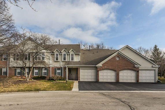 Front view of a two-story house with a three-car garage.
