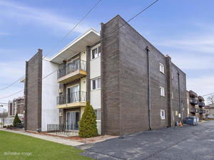 Front view of a multi-story building with balconies