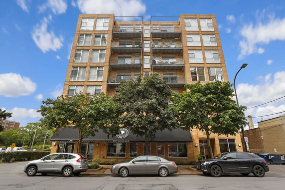 Front view of a multi-story building with balconies.