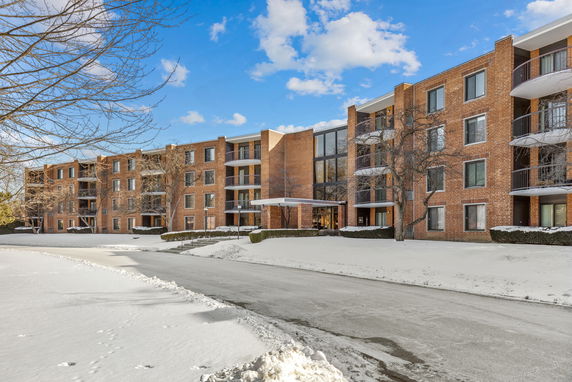 Front view of a multi-story brick apartment building.