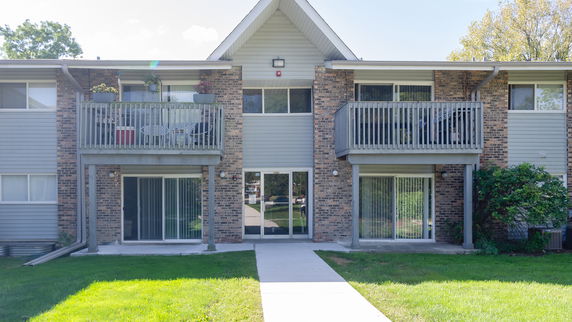 Front view of a two-story apartment building with balconies.
