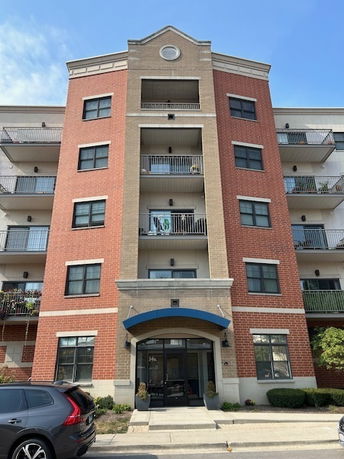 Front view of a mid-rise apartment building with balconies.