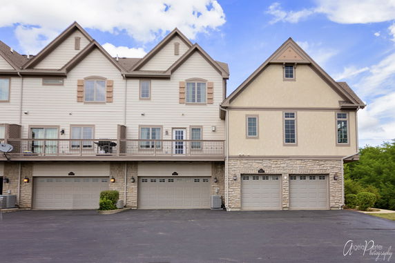 Front view of a multi-story house with multiple garages.