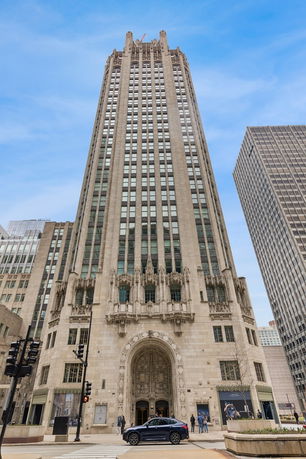 Front view of a tall, ornate skyscraper with intricate architectural details.