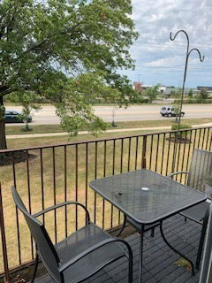 View from a balcony showing a road and trees.