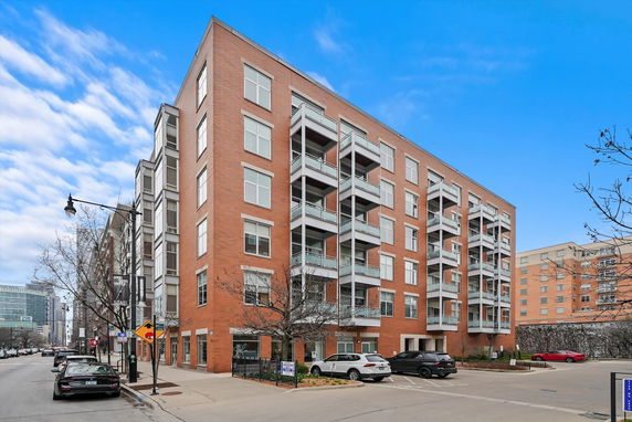 Front view of a multi-story residential building with balconies.