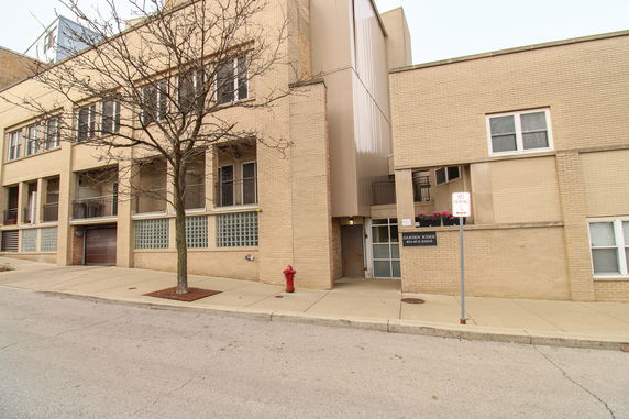 Front view of a multi-story building with glass block windows and an entrance sign labeled Garden Ridge.