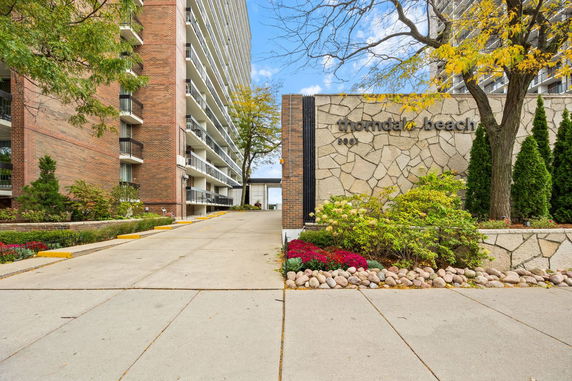 Front view of a multi-story residential building with balconies.