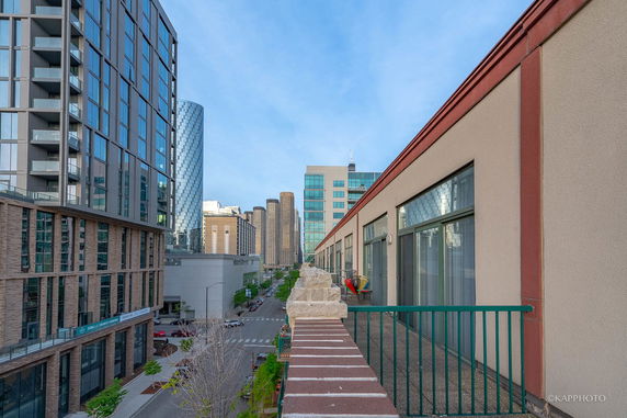 View of a cityscape with several modern buildings and a street.