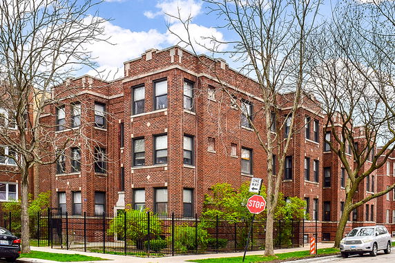Front view of a three-story brick apartment building.