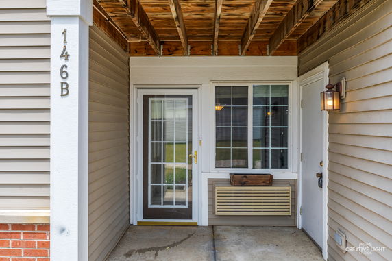 Entrance view of a house with a door and large window.