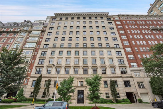 Front view of a multi-story building with numerous windows and a classic architectural design.