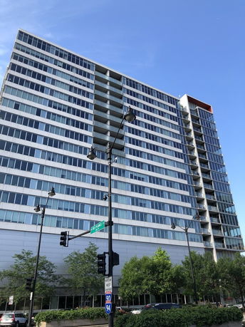 Front view of a multi-story building with a modern glass facade.