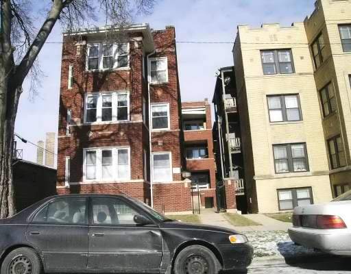 Front view of a multi-story brick apartment building.
