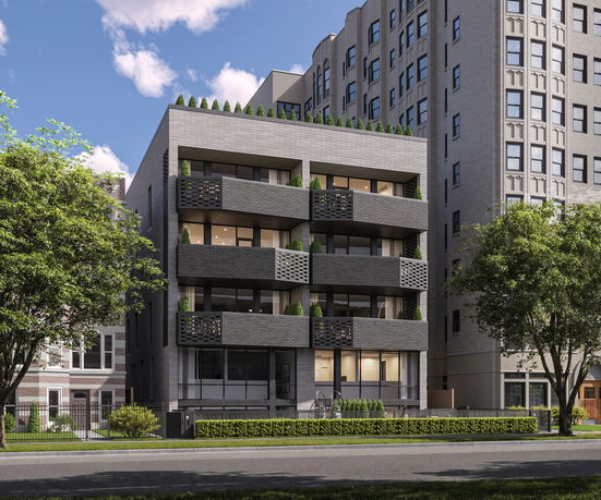 Front view of a modern multi-story building with balconies and rooftop greenery.