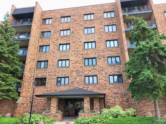 Front view of a multi-story brick apartment building.