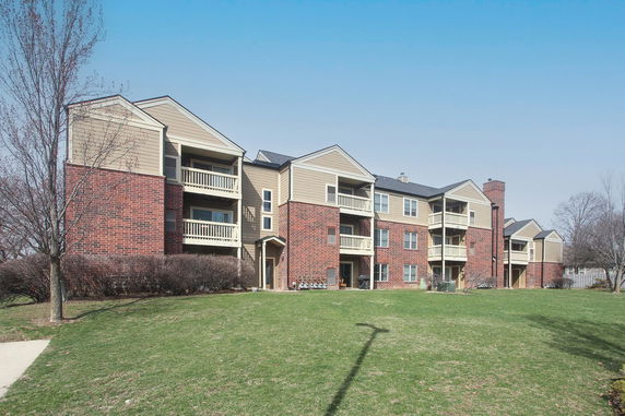 Front view of a multi-story apartment building with balconies.