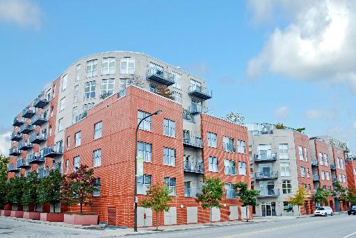Front view of a multi-story apartment building with modern design.