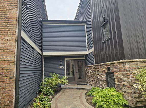 Front view of a house with brick and siding exterior.