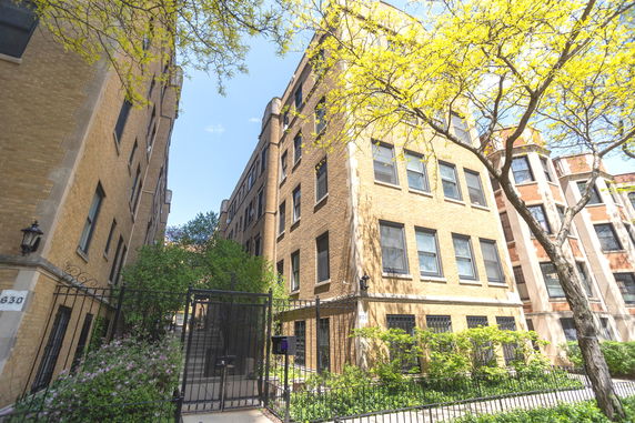 Front view of multi-story apartment buildings with brick exterior.