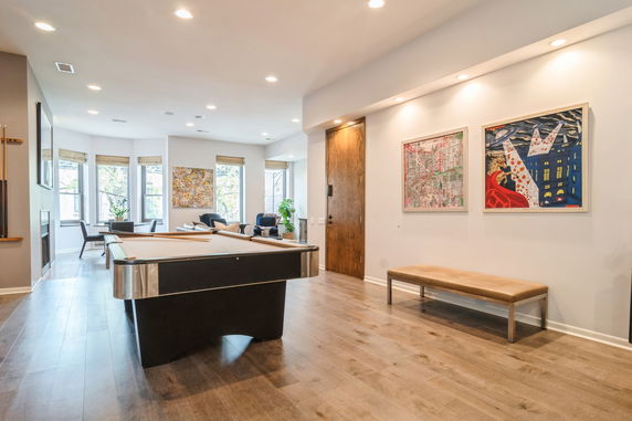Indoor recreation area with a pool table and seating.