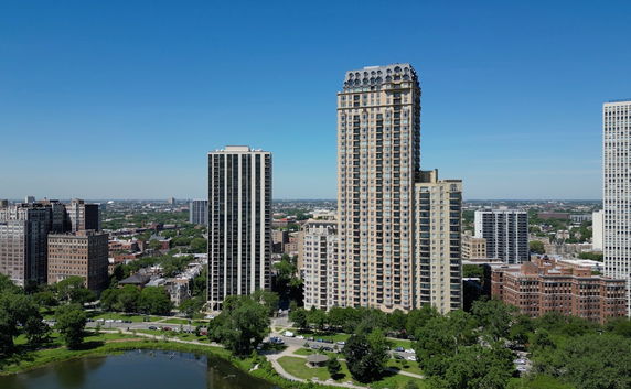 Front view of multiple high-rise residential buildings in a city skyline.